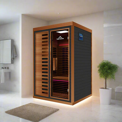 Infrared sauna in a modern bathroom setting with a plant and mirror.